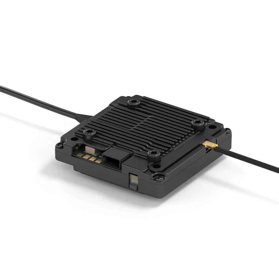 The HeadphoneHeat WalkSnail Avatar Pro Night Vision Edition HD is a compact black module with a ribbed rectangular casing for FPV goggles, 1080P 120fps support, and two cables—one USB and one gold connector—resting on a white surface.