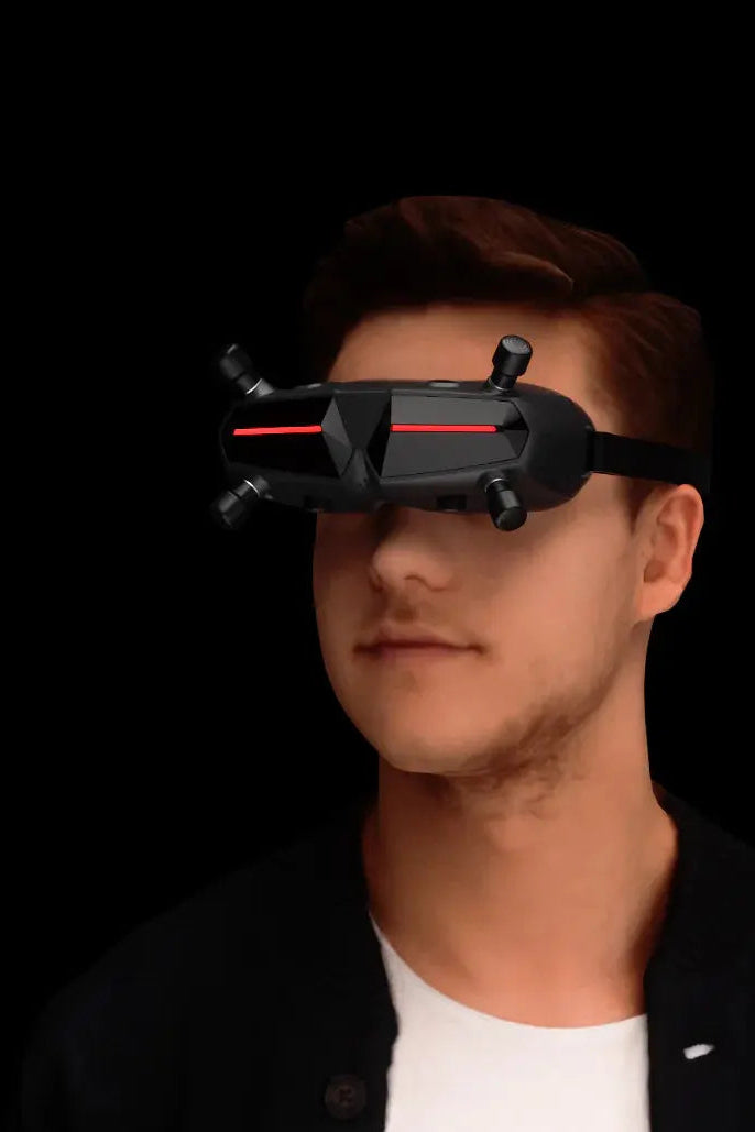 A split image displays a red off-road vehicle and a man wearing HeadphoneHeat’s WalkSnail Avatar Pro Night Vision Edition HD FPV goggles with built-in gyro, both set against a black background.