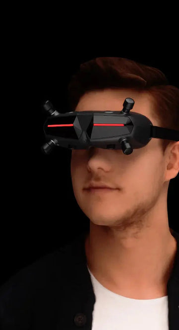 A split image displays a red off-road vehicle and a man wearing HeadphoneHeat’s WalkSnail Avatar Pro Night Vision Edition HD FPV goggles with built-in gyro, both set against a black background.